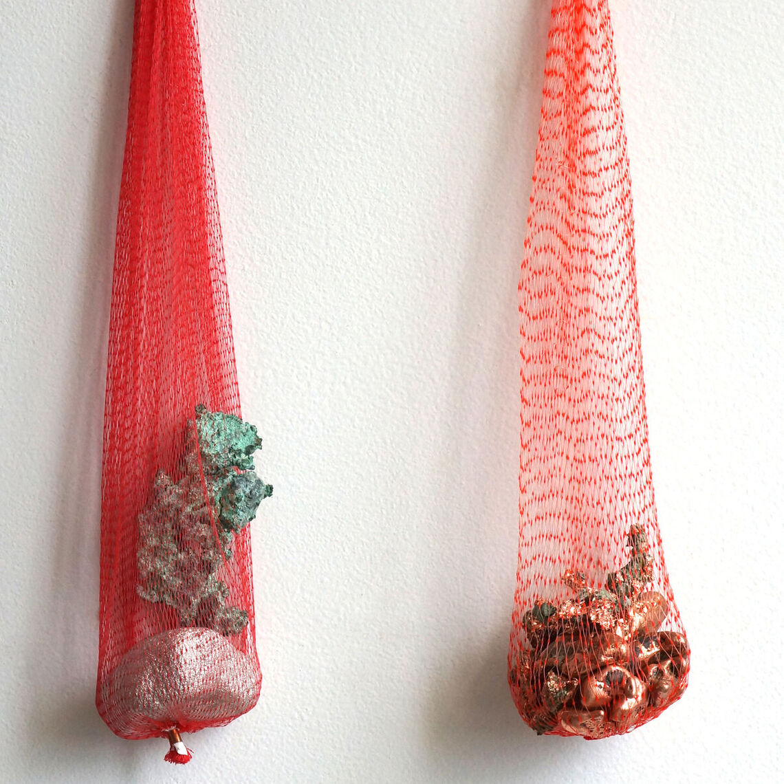 Inhabit (Copper), 2021.
Copper in three different states, plastic mesh sleeves for garlic, driftwood, glass beads.