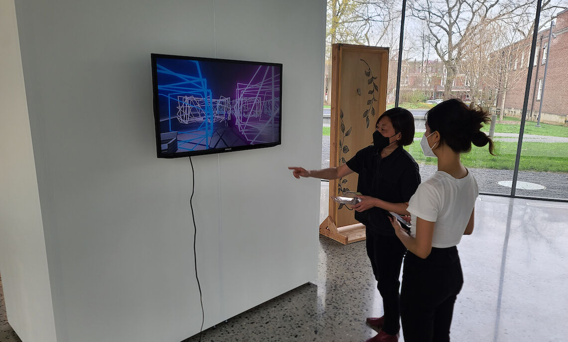Zhang installs her video with Lee’s assistance: “I really like this kind of narrative through space, so after I graduate, I will continue to study this area, such as curatorial and spatial design.”