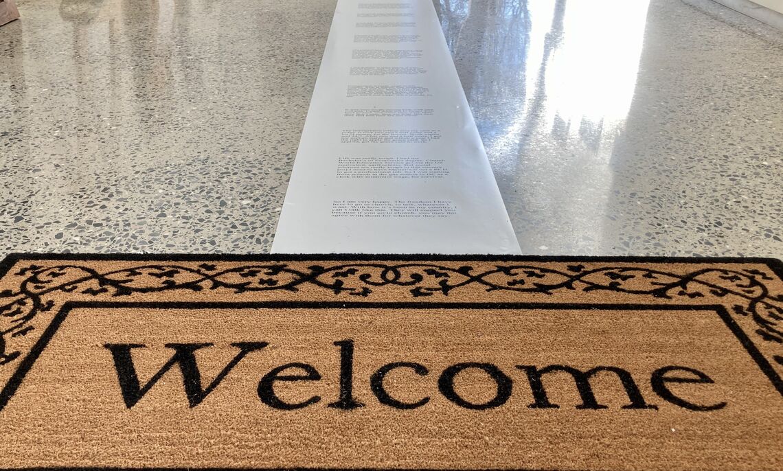 The welcome mat is one of the elements to reflect a migrant's journey.