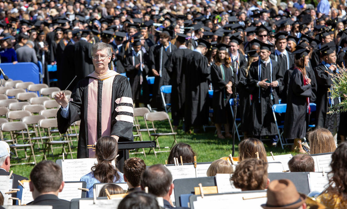 F&M's Senior Director of Instrumental Music and Conducting Studies Brian Norcross leads the Commencement Wind Ensemble in "Pomp and Circumstance" as the graduates assemble on Hartman Green.