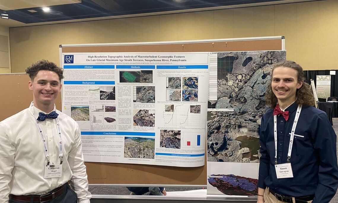 Cam Siegel and Simon Sauvageau, senior geoscience and environmental science majors, present a poster on high-resolution topographic analysis of extreme geomorphic features in the Pennsylvania’s Susquehanna River.