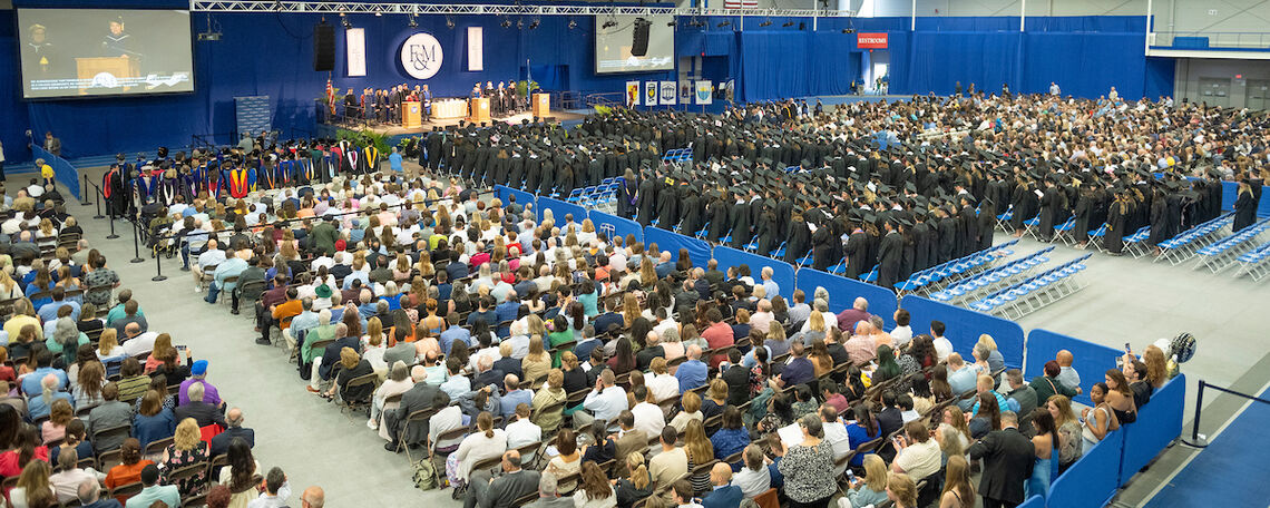 Class of 2023 grads gather in the Alumni Sports & Fitness Center.