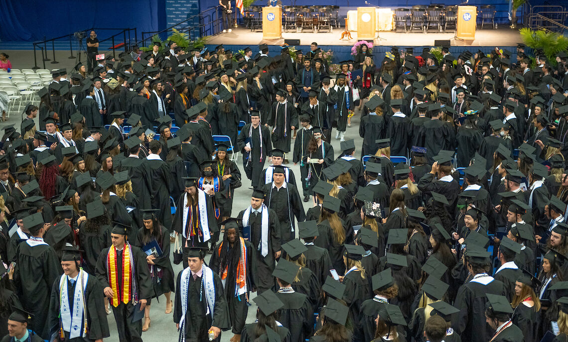 Class of 2023 grads gather in the Alumni Sports & Fitness Center.