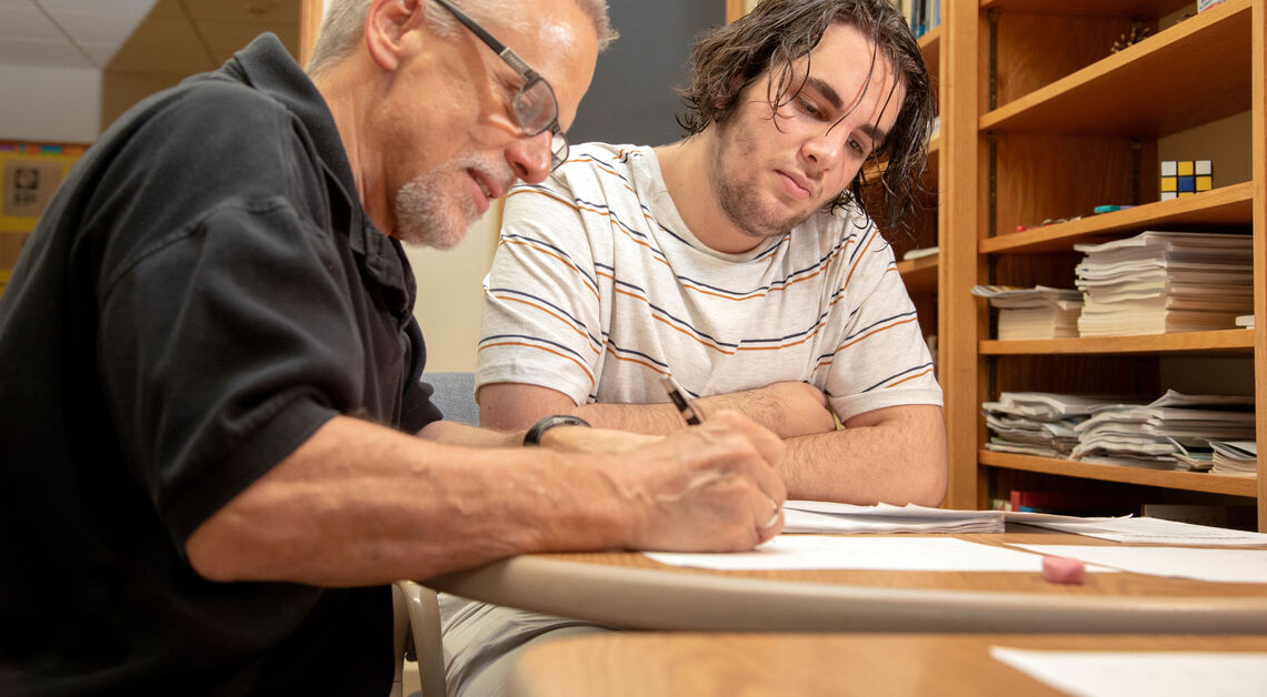 Professor Wendell Ressler joins Summer Hackman Scholar Nart Shalqini '21 in pondering a problem without a known answer, guiding the student to think about how to correctly frame his research question on algebraic number theory.