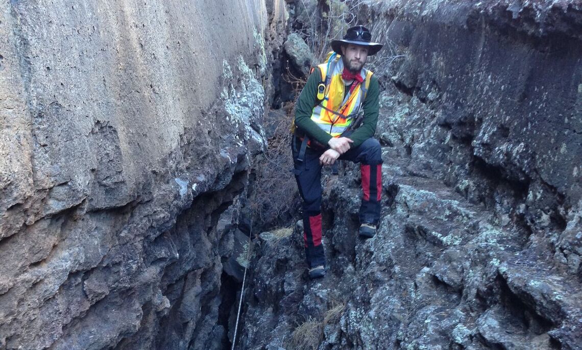 img 2... Jake Bleacher '00, NASA's Chief Exploration Scientist, between a crevice in the lava flow.