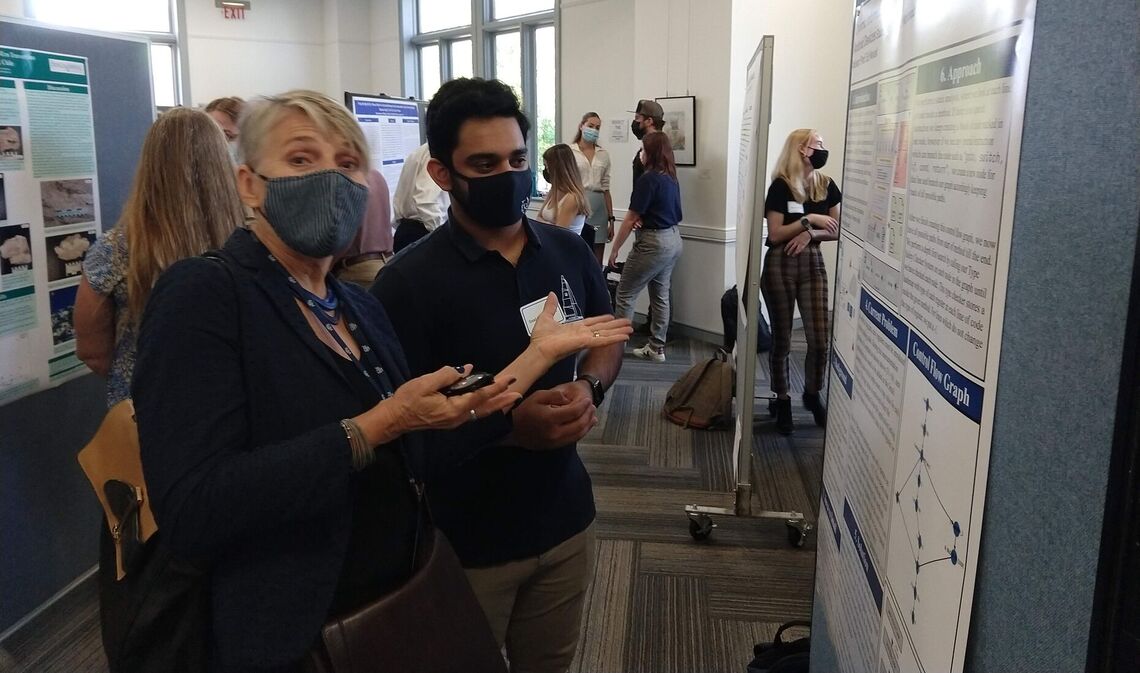 ... F&M President Barbara Altmann comments on Saad Mahboob's research poster, which was part of the 2021 Summer Experience Fair in October.