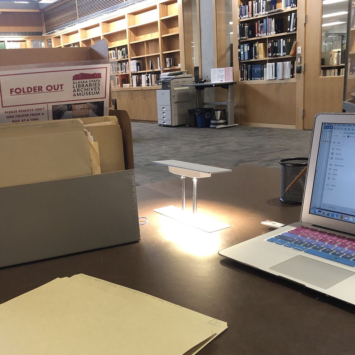 ... Ashley Guernsey '22 spent the summer exploring rare archives across Alaska. Depicted is her work station at the Alaska State Archives in Juneau.